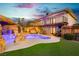 Backyard with a two-story home, balcony, pool, and outdoor seating areas at 200 E Desert Rose Dr, Henderson, NV 89015