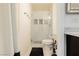 This bathroom features tiled shower, shower glass, a white toilet and chrome shower head at 200 E Desert Rose Dr, Henderson, NV 89015