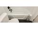 This bathroom features a white tub and toilet on stylish black hexagon tile at 200 E Desert Rose Dr, Henderson, NV 89015