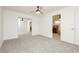 Bedroom with gray carpet features a mirrored closet and a ceiling fan at 200 E Desert Rose Dr, Henderson, NV 89015
