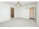 A bright bedroom features neutral walls and carpet under a modern ceiling fan at 200 E Desert Rose Dr, Henderson, NV 89015
