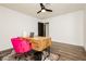 Bedroom with desk, ceiling fan, wood floors, natural light, and colorful decor at 200 E Desert Rose Dr, Henderson, NV 89015