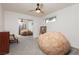 This bedroom features a comfortable beanbag chair, neutral carpet, and a ceiling fan at 200 E Desert Rose Dr, Henderson, NV 89015