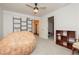 This bedroom has neutral carpet, a ceiling fan, and shelving for storage at 200 E Desert Rose Dr, Henderson, NV 89015
