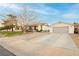 Charming single-Gathering home with a well-maintained lawn and a spacious driveway with an attached garage at 200 E Desert Rose Dr, Henderson, NV 89015