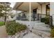 Comfortable front porch with railing, stone stairs, and beautiful landscaping at 200 E Desert Rose Dr, Henderson, NV 89015