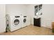 Functional laundry room featuring a washer, dryer, and utility sink at 200 E Desert Rose Dr, Henderson, NV 89015
