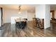 Open concept living room with stylish dining table, wine rack, brick fireplace, and wood floors at 200 E Desert Rose Dr, Henderson, NV 89015