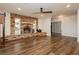 Spacious living room featuring a brick fireplace, wood floors, and modern ceiling fan at 200 E Desert Rose Dr, Henderson, NV 89015