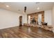 Cozy living room features a brick fireplace, hardwood floors, and bright, natural lighting at 200 E Desert Rose Dr, Henderson, NV 89015