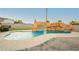 Backyard pool features a rock waterfall and grotto, offering a fun and relaxing outdoor experience at 200 E Desert Rose Dr, Henderson, NV 89015