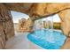 A unique grotto and waterfall feature enhance this backyard pool, perfect for leisure and recreation at 200 E Desert Rose Dr, Henderson, NV 89015