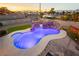 Beautiful pool features a rock waterfall, slide and custom lighting to create a backyard paradise at 200 E Desert Rose Dr, Henderson, NV 89015