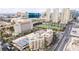 Aerial view of the property showcasing tennis courts, golf course, and city views at 205 E Harmon Ave # 112, Las Vegas, NV 89169