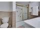 Bathroom featuring decorative wall tiles, standard toilet and shower-tub at 205 E Harmon Ave # 112, Las Vegas, NV 89169