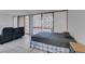 Open concept bedroom with adjacent living area, sliding glass door and tiled flooring at 205 E Harmon Ave # 112, Las Vegas, NV 89169
