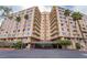 A bright, multi-story condo building with palm trees and a covered entry at 205 E Harmon Ave # 112, Las Vegas, NV 89169
