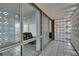 Hallway with decorative block wall and large glass windows overlooking an office space at 205 E Harmon Ave # 112, Las Vegas, NV 89169
