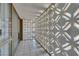 Hallway with decorative block wall and large glass windows on a tile floor at 205 E Harmon Ave # 112, Las Vegas, NV 89169