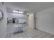 Modern kitchen pass-through with tiled flooring and bright lighting at 205 E Harmon Ave # 112, Las Vegas, NV 89169