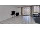 A bright, neutral space with tiled floors, sliding balcony doors and sofa at 205 E Harmon Ave # 112, Las Vegas, NV 89169