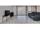 Large tiled living space with decorative sliding doors to balcony at 205 E Harmon Ave # 112, Las Vegas, NV 89169