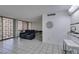 Open-concept living area with kitchen bar, seating and bright patio doors at 205 E Harmon Ave # 112, Las Vegas, NV 89169