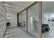 A view of the interior through the patio's decorative block wall and sliding glass doors at 205 E Harmon Ave # 112, Las Vegas, NV 89169