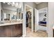 Bathroom with dual sinks, granite countertops, and walk-in closet access at 2159 Morro Vista Dr, Las Vegas, NV 89135