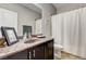 Bathroom features a framed mirror over a dark vanity and shower-tub with curtain at 2159 Morro Vista Dr, Las Vegas, NV 89135