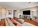 Comfortable living room with hardwood floors, a large sectional sofa, and a modern entertainment center at 2159 Morro Vista Dr, Las Vegas, NV 89135