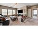 Spacious living room with plush carpet, a comfortable sofa, and a large television at 2159 Morro Vista Dr, Las Vegas, NV 89135