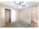 Bedroom with neutral walls, carpet flooring, closet, and ceiling fan for modern living at 2319 Little Italy Ave, North Las Vegas, NV 89031