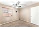 Cozy bedroom with neutral walls, ceiling fan, and window, offering a comfortable retreat at 2319 Little Italy Ave, North Las Vegas, NV 89031