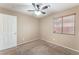 Carpeted bedroom featuring a ceiling fan, window, and closet for storage at 2319 Little Italy Ave, North Las Vegas, NV 89031