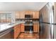 Well-equipped kitchen with stainless steel appliances, oak cabinets and wood floors at 2319 Little Italy Ave, North Las Vegas, NV 89031