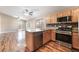 Well-equipped kitchen with stainless steel appliances, oak cabinets, island and wood floors at 2319 Little Italy Ave, North Las Vegas, NV 89031
