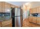 View of a kitchen with stainless steel refrigerator and adjacent access to laundry room at 2319 Little Italy Ave, North Las Vegas, NV 89031