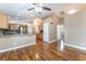 Eat-in kitchen features wood cabinets, stainless appliances, and granite countertops overlooking the living area at 2319 Little Italy Ave, North Las Vegas, NV 89031