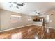 Open floor plan, living room features wood floors, natural light and looks into the kitchen at 2319 Little Italy Ave, North Las Vegas, NV 89031