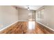 Bright living room with wood flooring, large windows, and sliding door access to the outdoor patio at 2319 Little Italy Ave, North Las Vegas, NV 89031