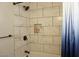 Bathroom features a tiled shower with modern fixtures, a shower niche, and a blue shower curtain at 2874 Tori Way, Henderson, NV 89074