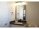 Bathroom features a modern vanity with a sleek sink and faucet, accented by a large mirror at 2874 Tori Way, Henderson, NV 89074