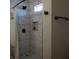 Bathroom features a tiled shower with modern fixtures, a shower niche, and gray tile flooring at 2874 Tori Way, Henderson, NV 89074