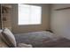Bedroom featuring a cozy bed, corner shelves and a bright window, creating a relaxing atmosphere at 2874 Tori Way, Henderson, NV 89074