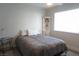 Bedroom featuring a cozy bed, corner shelves and a bright window, creating a relaxing atmosphere at 2874 Tori Way, Henderson, NV 89074
