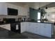 Kitchen with white cabinets, black appliances, granite countertops, and tiled backsplash at 2874 Tori Way, Henderson, NV 89074