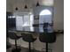 Open-concept kitchen with bar seating, granite countertops, white cabinets, and stainless steel appliances at 2874 Tori Way, Henderson, NV 89074