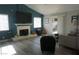 Bright living room with a fireplace, large windows, and modern furnishings at 2874 Tori Way, Henderson, NV 89074