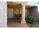 Inviting covered patio with seating area framed by elegant columns and a round window at 2874 Tori Way, Henderson, NV 89074
